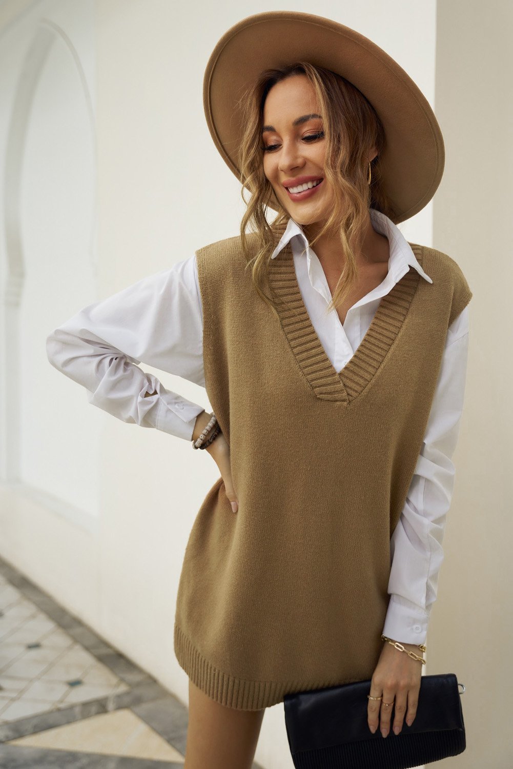 A stylish khaki Knit Pullover Vest Sweater featuring a v-neckline, sleeveless design, and high-low hemline with side slits.