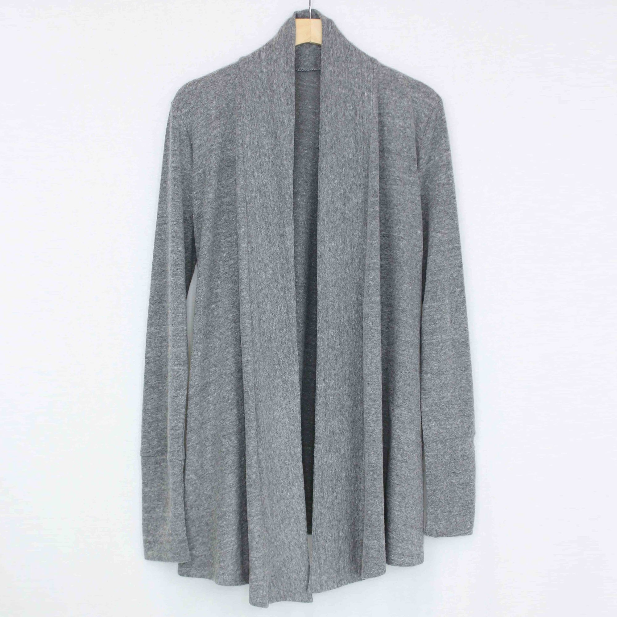 A stylish long sleeve open front cardigan in a soft fabric, featuring side pockets and a comfortable fit, perfect for casual wear.