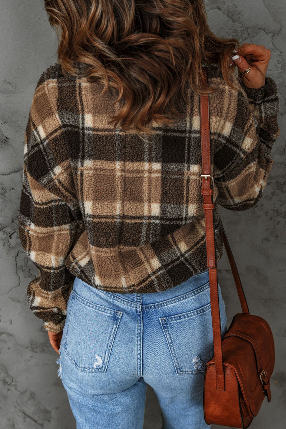 A stylish plaid pattern fleece sweatshirt featuring a cozy sherpa design, zip collar, and adjustable drawstring hem in brown color.