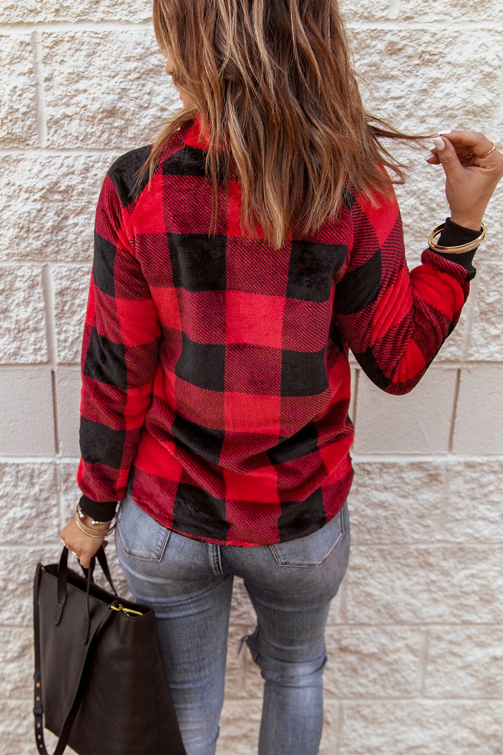 Red plaid paneled sweatshirt with asymmetric snap buttons and geometric stitching, perfect for winter wear.