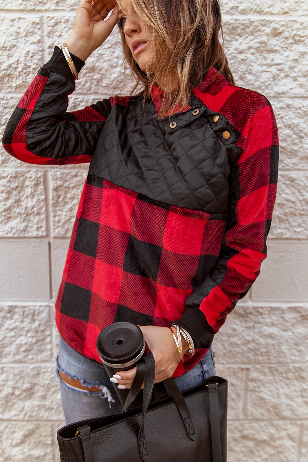 Red plaid paneled sweatshirt with asymmetric snap buttons and geometric stitching, perfect for winter wear.