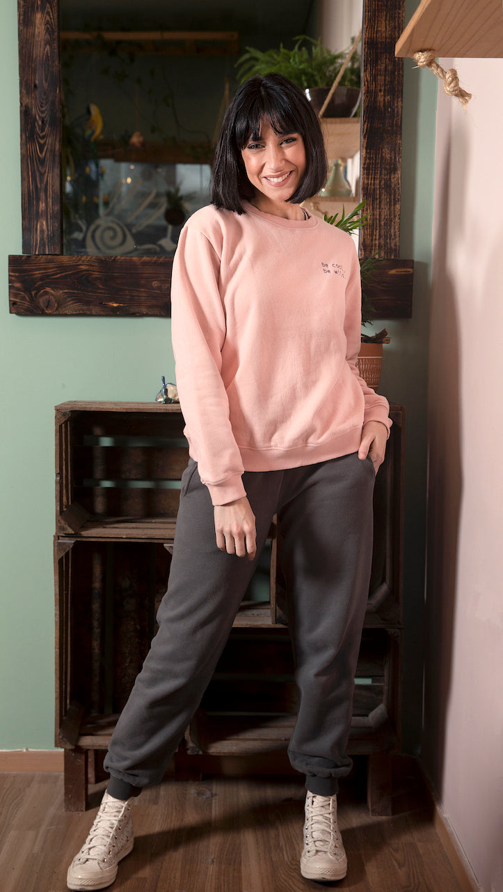 A stylish Bass Grey sweatshirt for women featuring ribbed cuffs, neckline, and a playful side print that says 'be cool, be wild'.