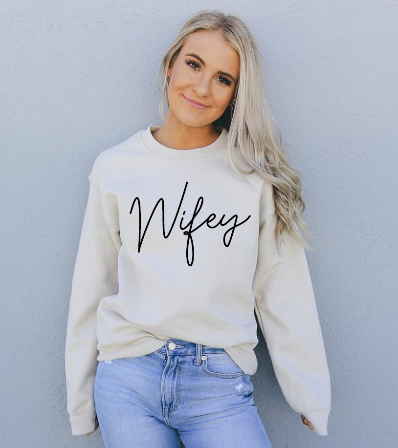 A cozy Wifey Sweatshirt in a stylish unisex design, featuring a crew neck and soft fabric.