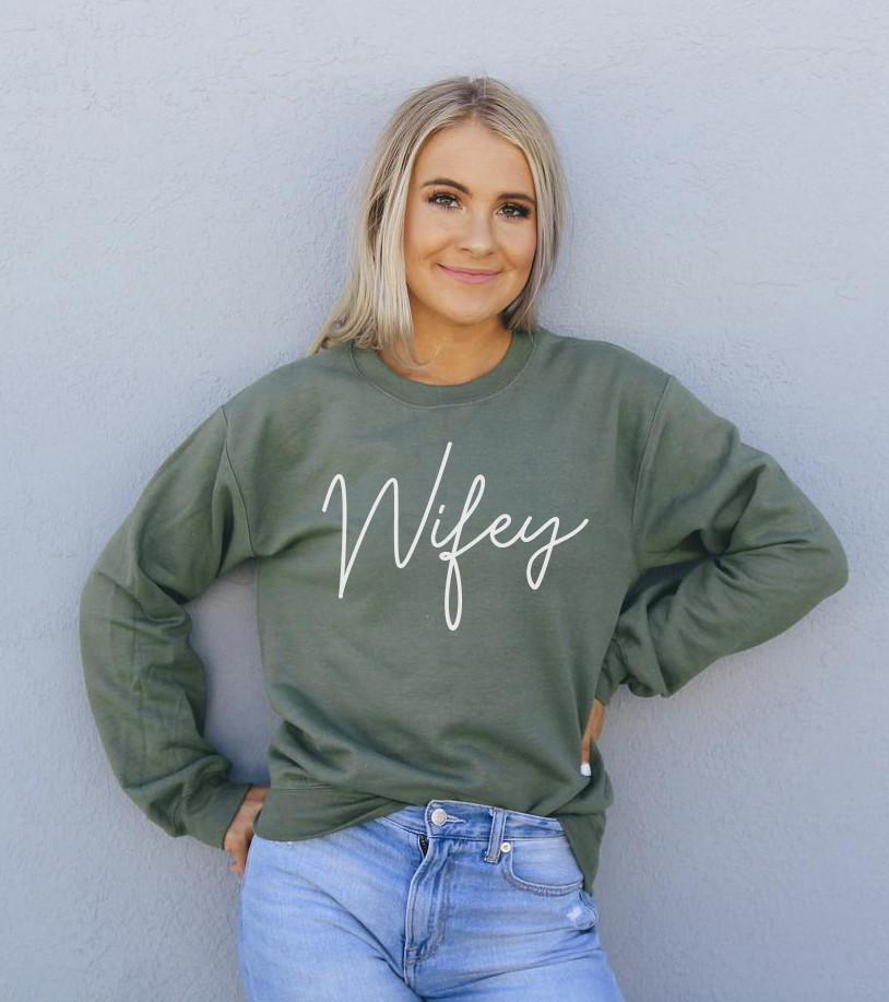 A cozy Wifey Sweatshirt in a stylish unisex design, featuring a crew neck and soft fabric.