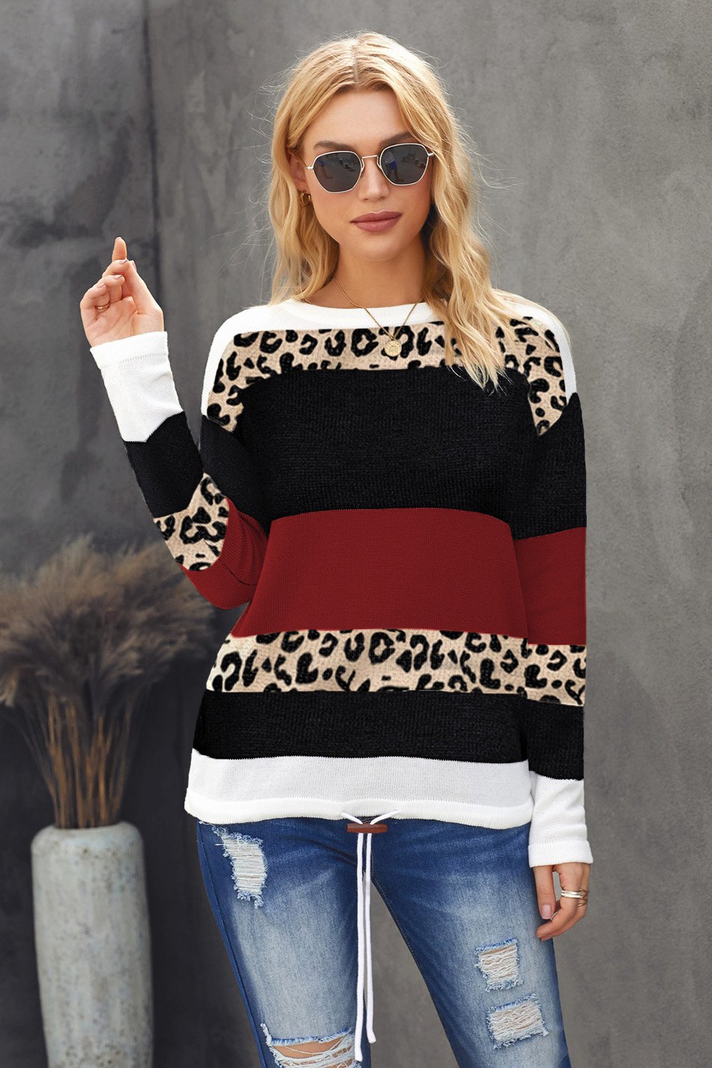 A stylish Wine Color Block Sweater featuring a chic leopard pattern and a cozy pullover design, perfect for fall and winter wear.