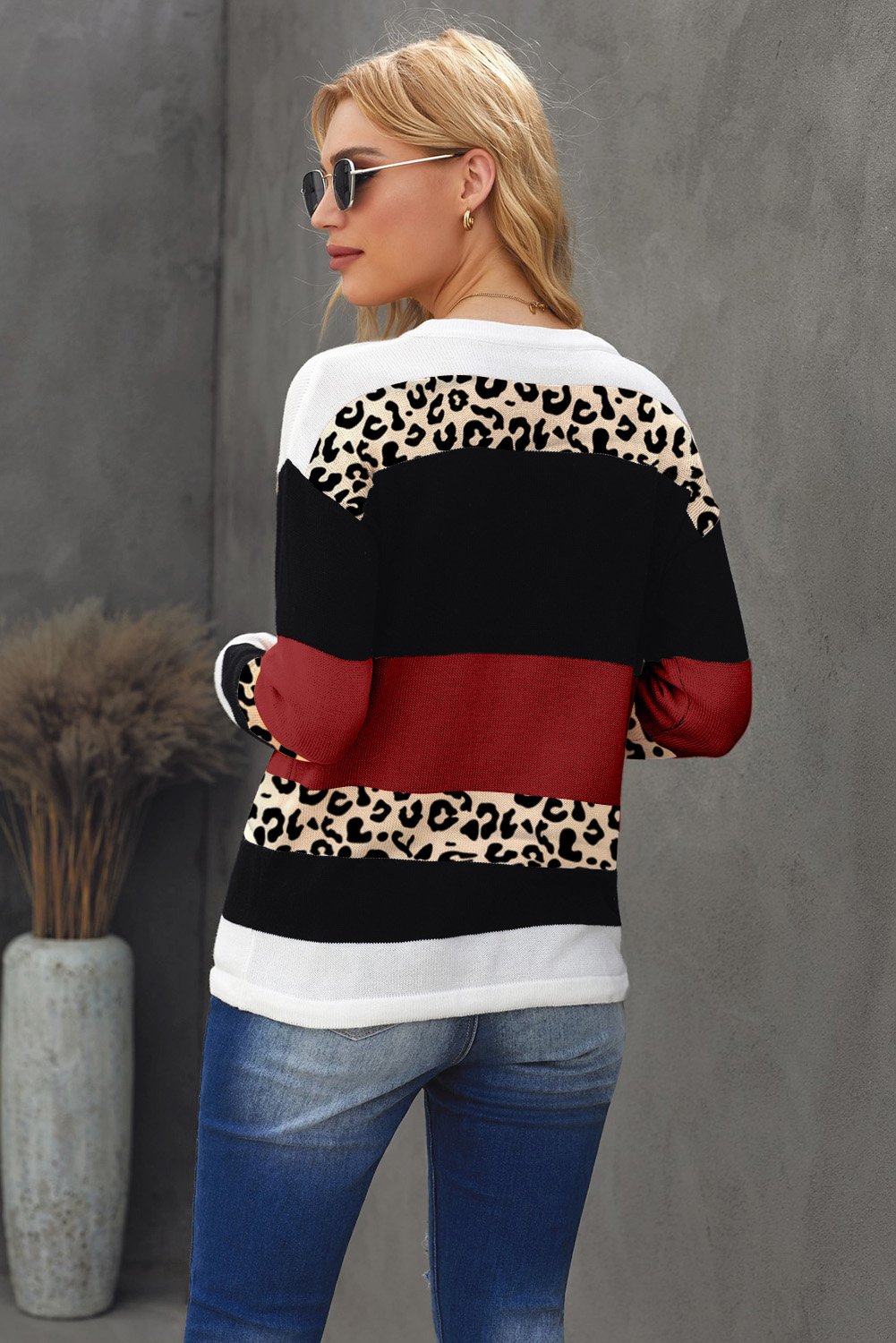 A stylish Wine Color Block Sweater featuring a chic leopard pattern and a cozy pullover design, perfect for fall and winter wear.