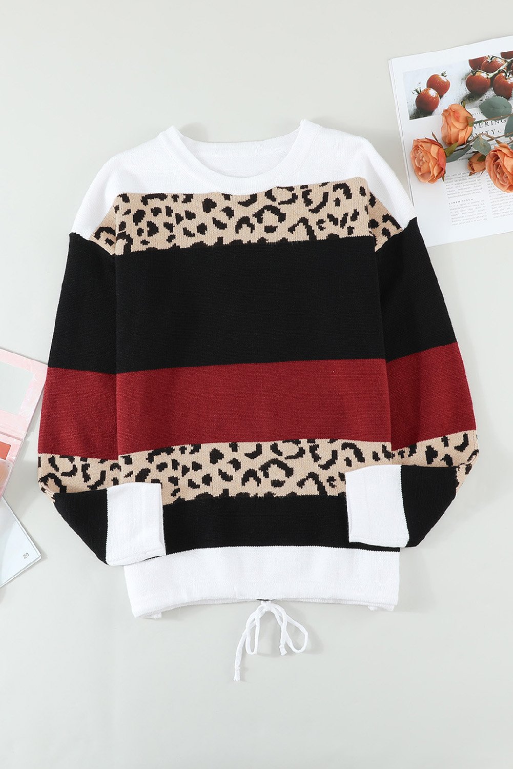 A stylish Wine Color Block Sweater featuring a chic leopard pattern and a cozy pullover design, perfect for fall and winter wear.