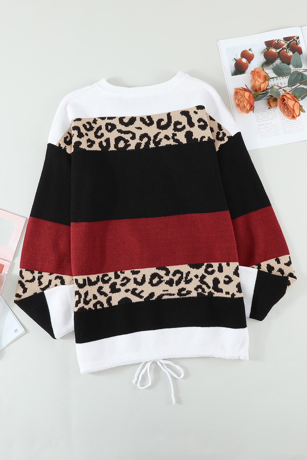 A stylish Wine Color Block Sweater featuring a chic leopard pattern and a cozy pullover design, perfect for fall and winter wear.