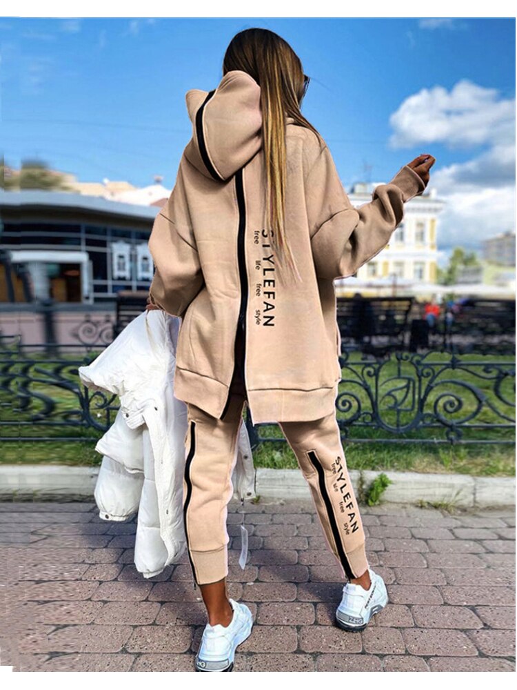 Women wearing an oversized letter print sweatshirt and ankle-length pants tracksuit set, showcasing a stylish and comfortable autumn/winter outfit.