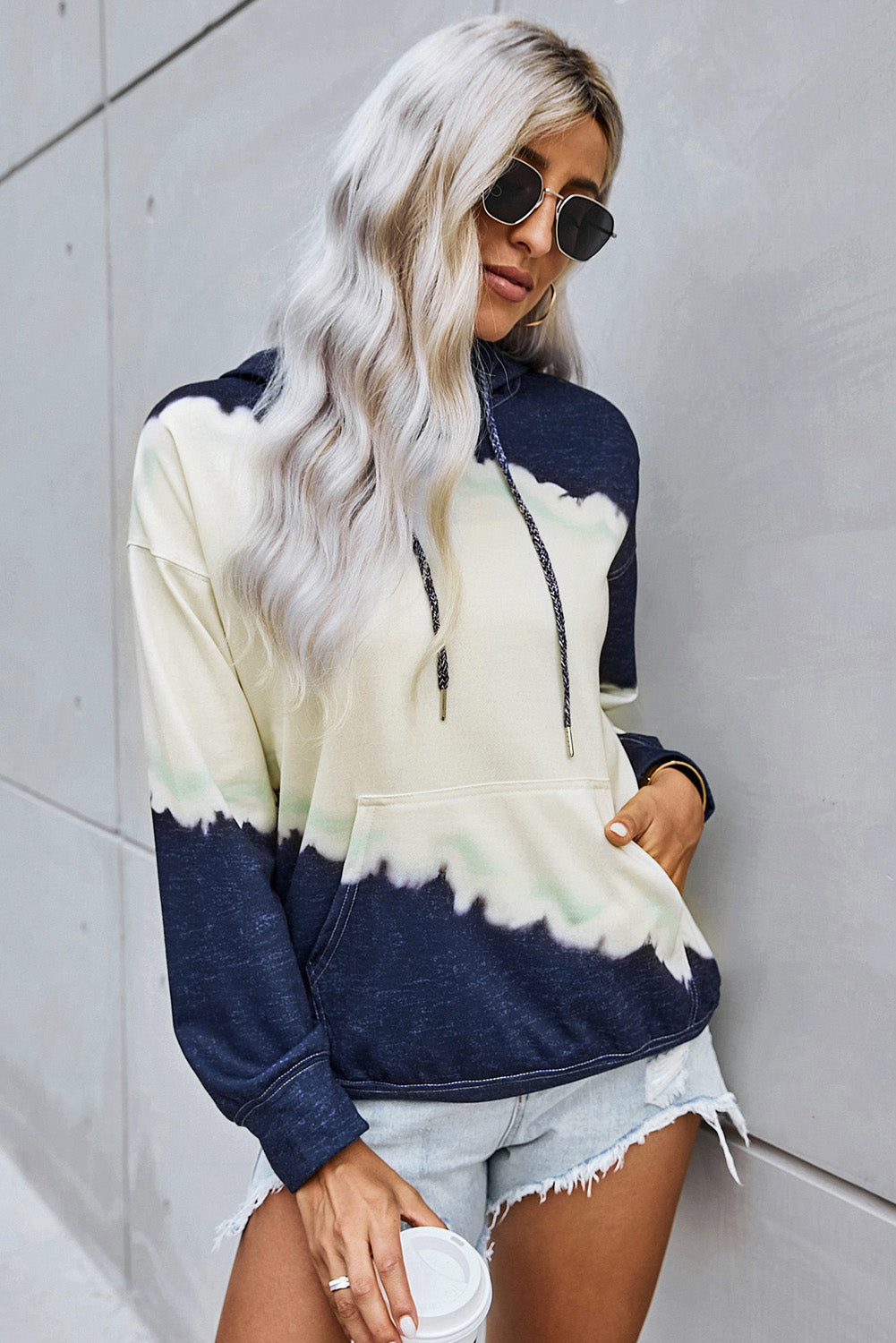 Women wearing a navy tie dye print casual hooded sweatshirt with pockets, showcasing a stylish and comfortable design.