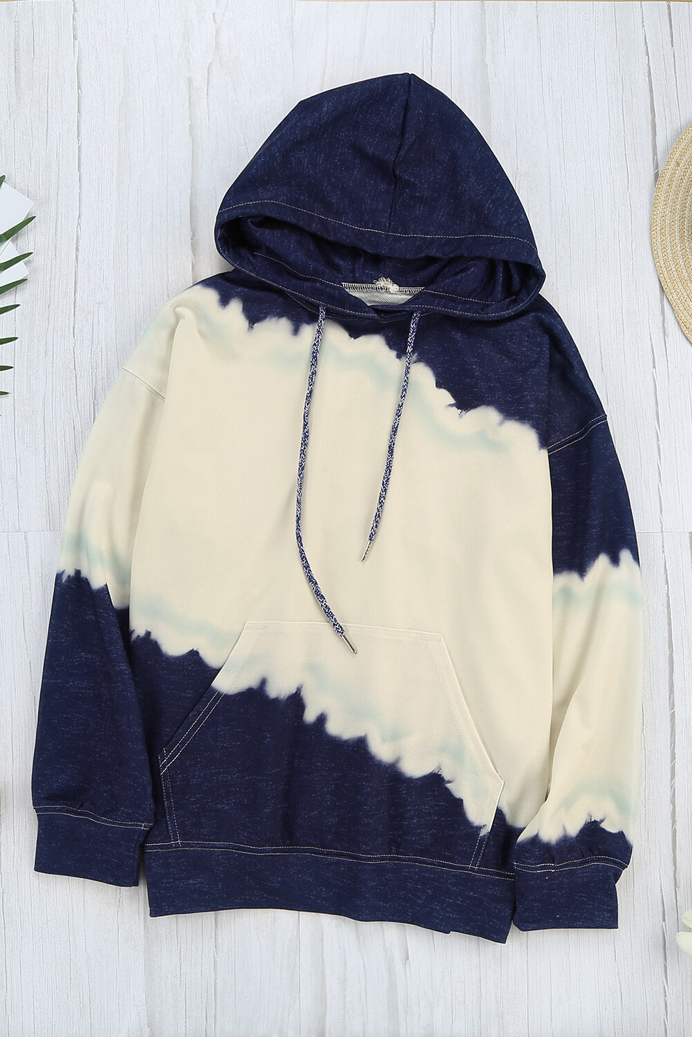 Women wearing a navy tie dye print casual hooded sweatshirt with pockets, showcasing a stylish and comfortable design.