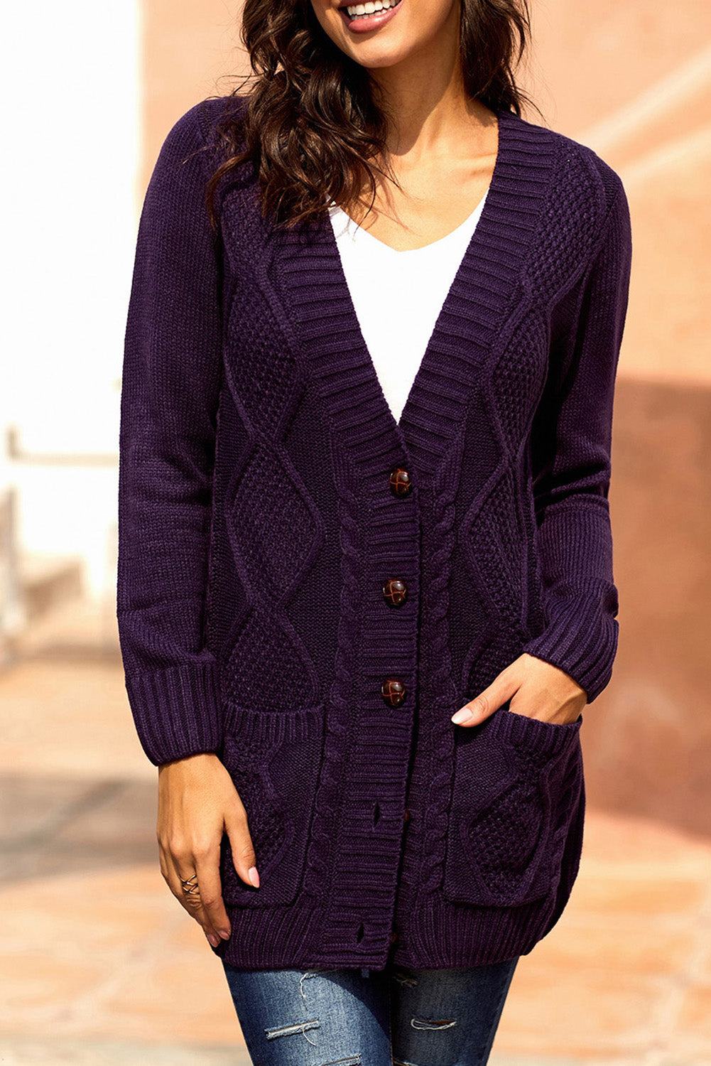 Women wearing a purple cardigan with front pockets and button closure, showcasing a stylish knit pattern.