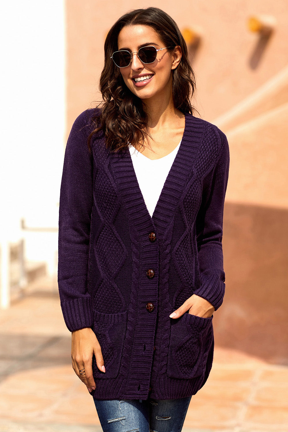 Women wearing a purple cardigan with front pockets and button closure, showcasing a stylish knit pattern.