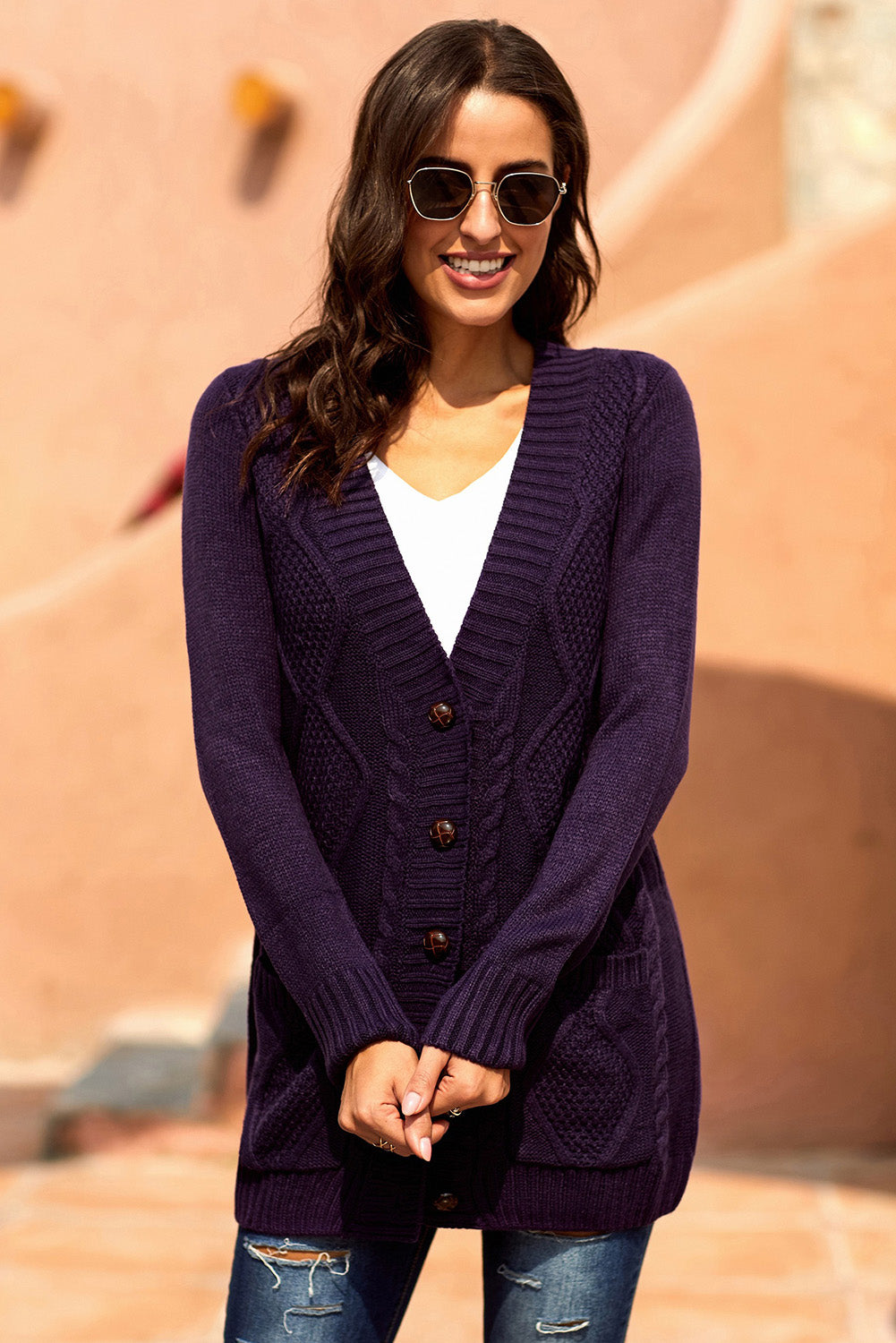 Women wearing a purple cardigan with front pockets and button closure, showcasing a stylish knit pattern.