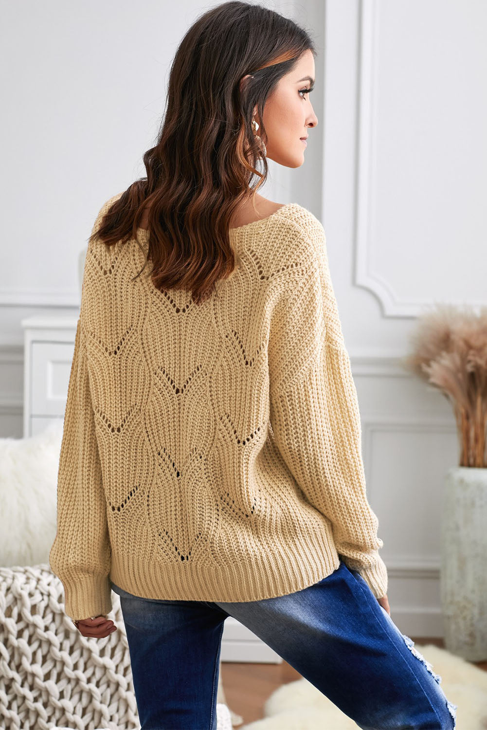 Women's khaki hollow-out knitted sweater featuring a round neck and long sleeves, showcasing a unique texture and elegant design.