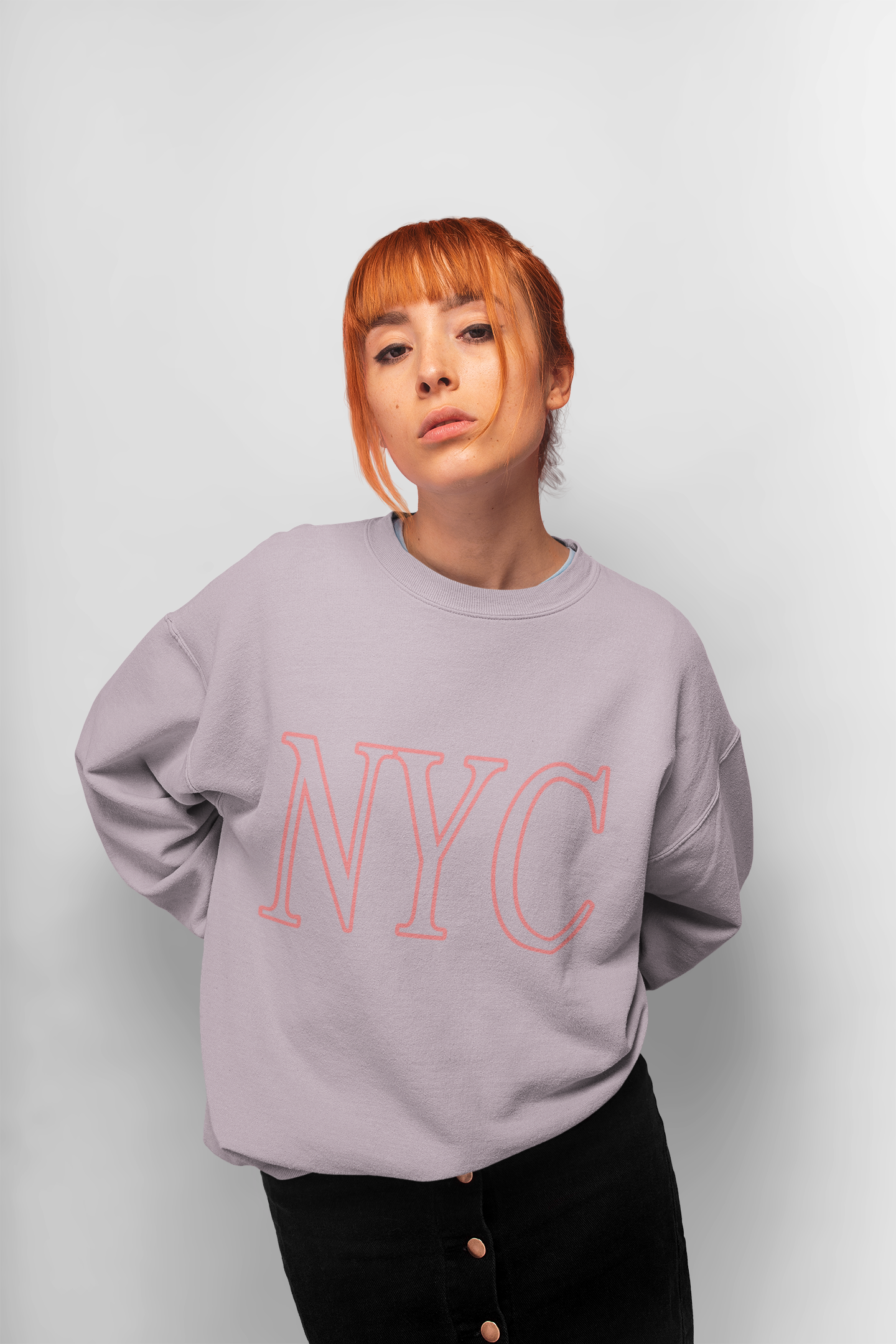 Womens Pink NYC Crewneck Sweatshirt displayed on a mannequin, showcasing its loose fit and stylish logo.