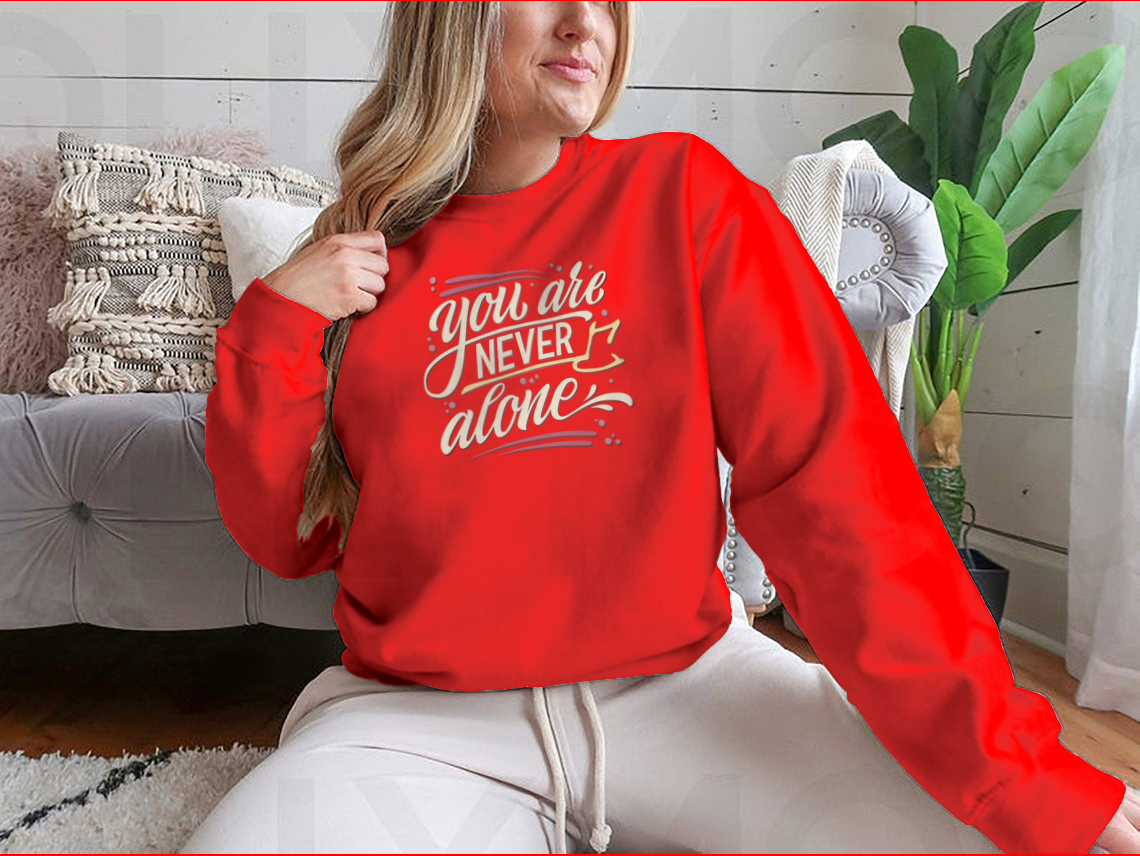 A comfortable cotton t-shirt featuring the hand-drawn lettering phrase 'You Are Never Alone', promoting mental health awareness.