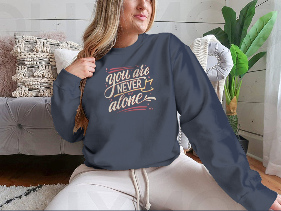 A comfortable cotton t-shirt featuring the hand-drawn lettering phrase 'You Are Never Alone', promoting mental health awareness.