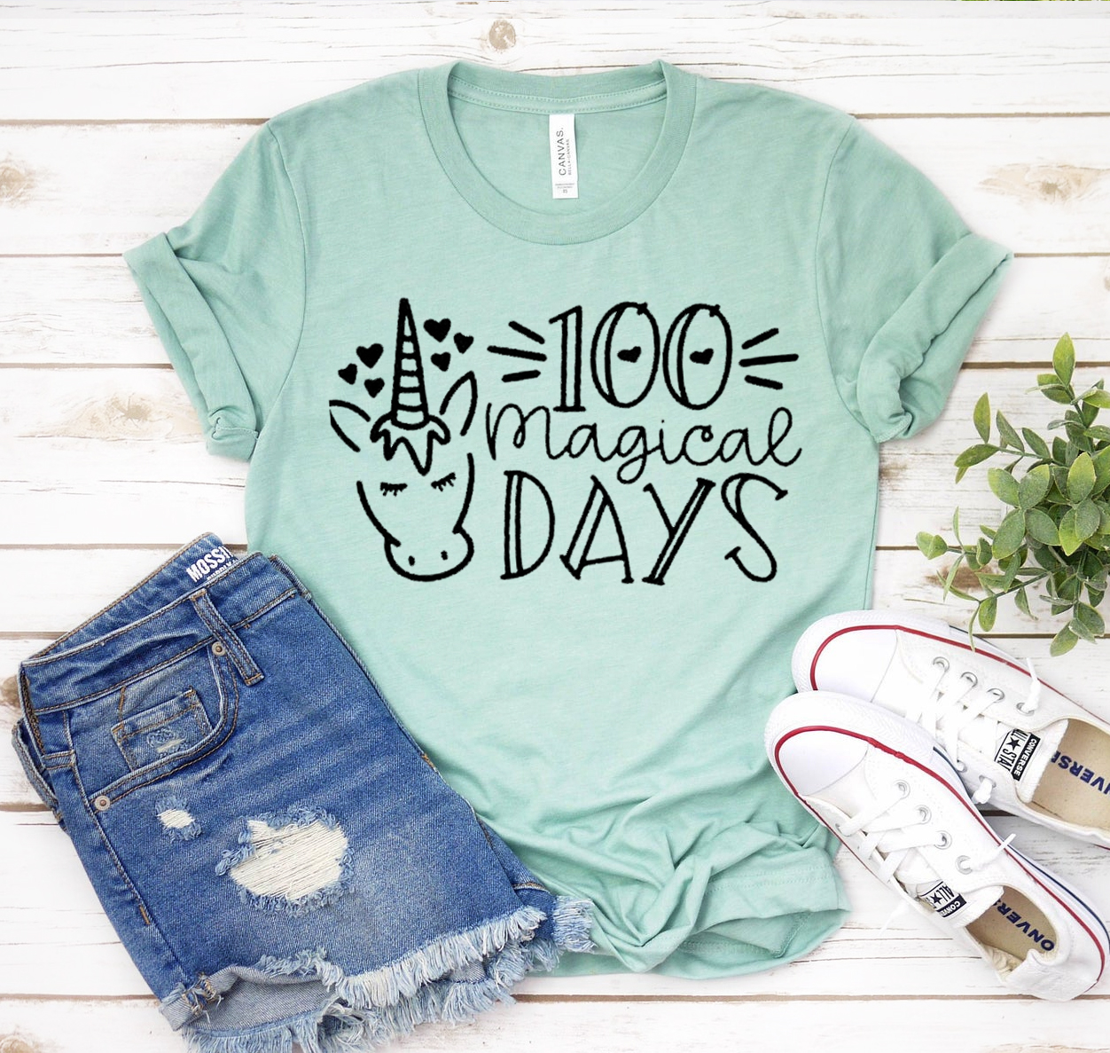 A unisex 100 Magical Days T-shirt displayed on a mannequin, showcasing its soft fabric and classic design.