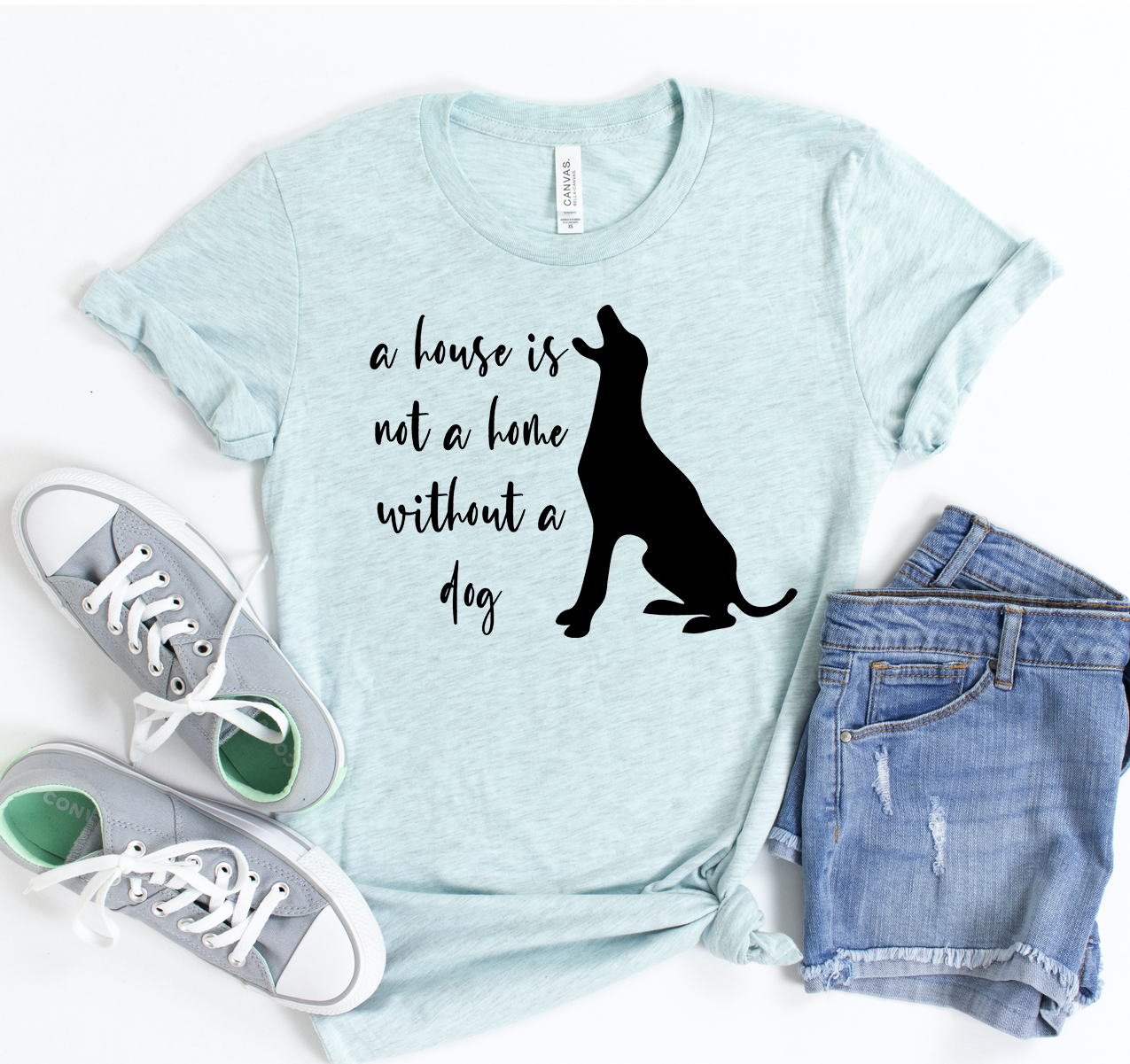 A stylish unisex t-shirt featuring the phrase 'A House Is Not A Home Without A Dog', made from soft cotton fabric.