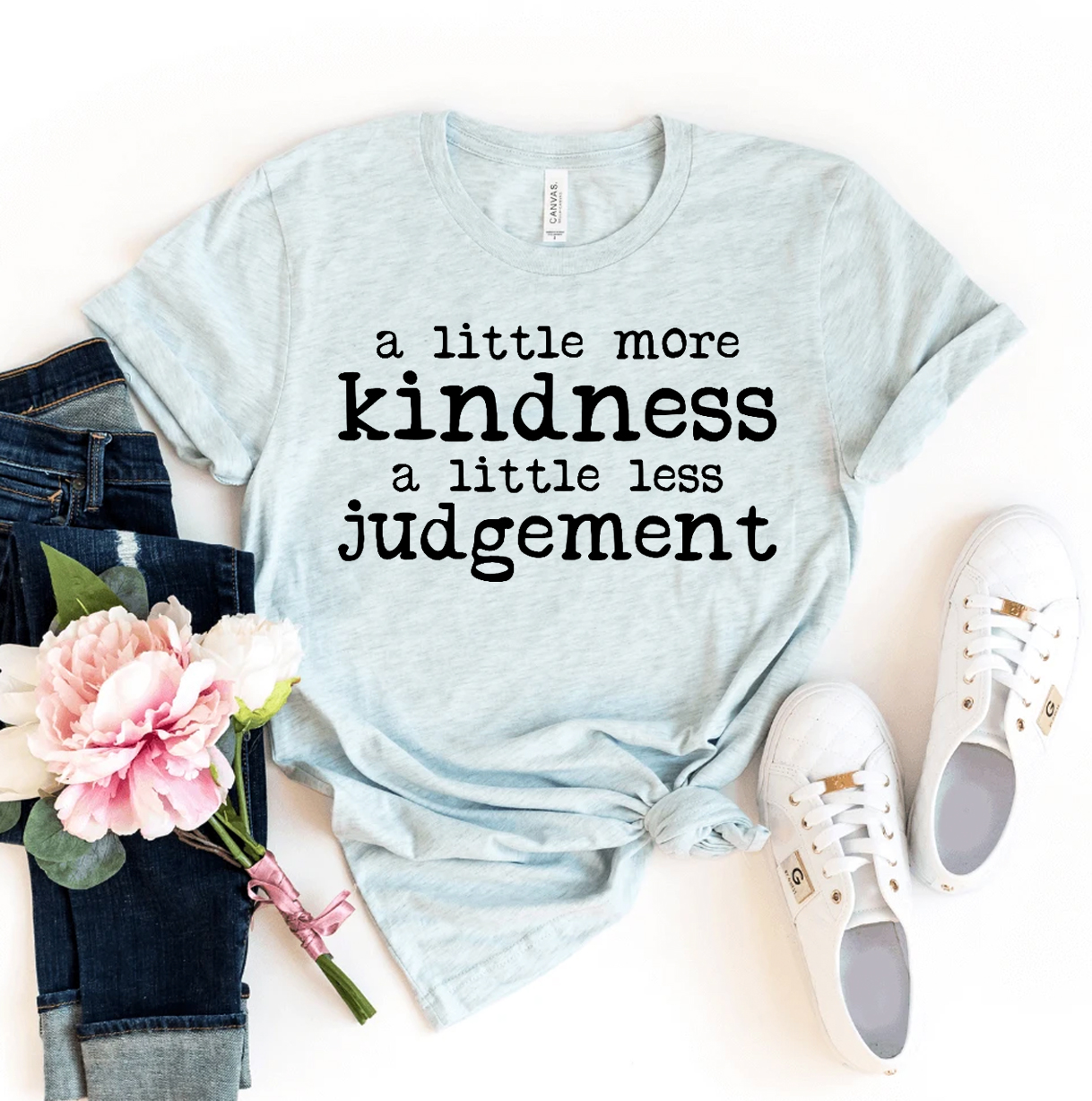 A Little More Kindness T-shirt made of premium ring spun cotton, featuring a soft textile flex print design in a comfortable retail fit.