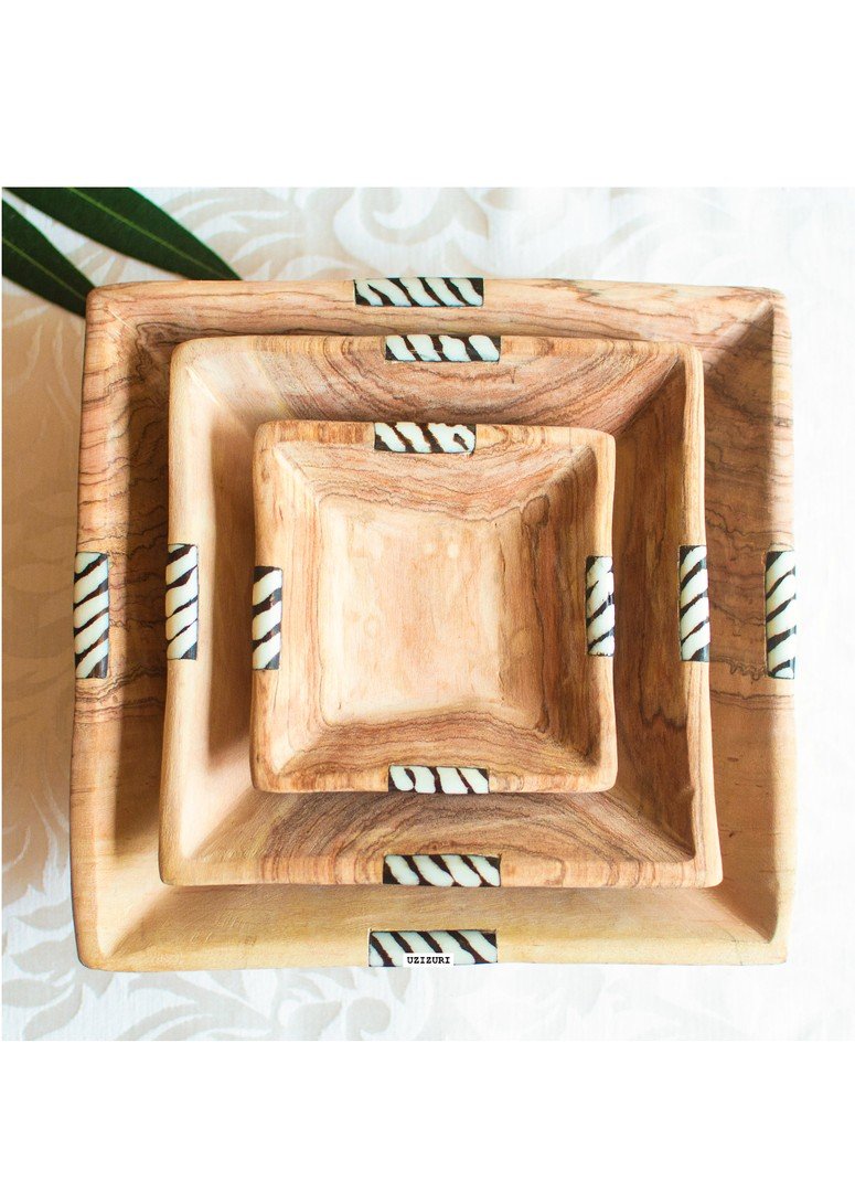 A set of three African olive wood squared salad bowls in varying sizes, showcasing unique grain patterns and a natural finish.