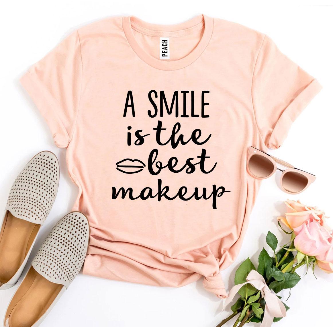 A stylish t-shirt featuring the phrase 'A Smile Is The Best Makeup' printed in vibrant colors on premium cotton fabric.