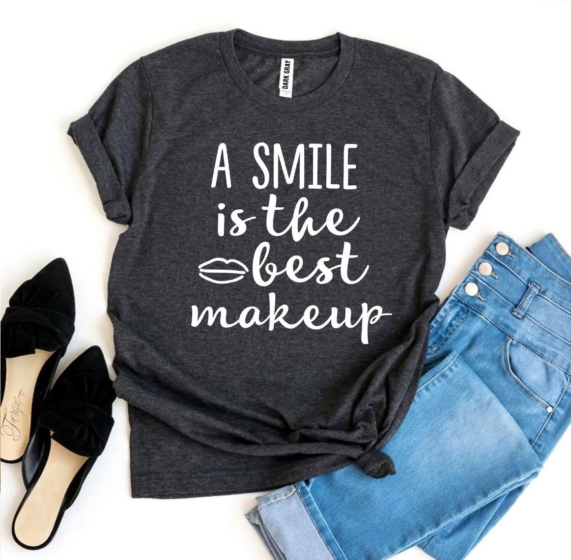 A stylish t-shirt featuring the phrase 'A Smile Is The Best Makeup' printed in vibrant colors on premium cotton fabric.