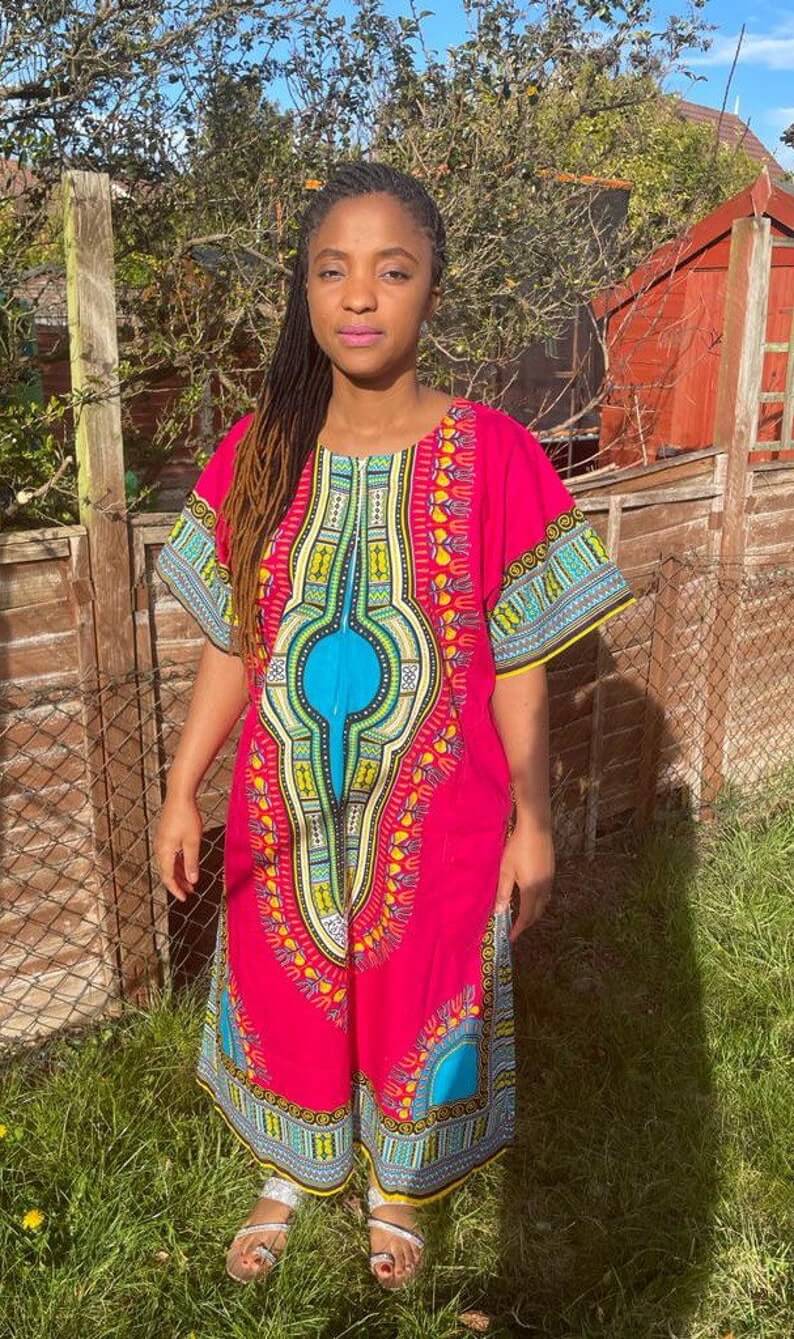 A vibrant pink African Dashiki Dress featuring traditional prints, showcasing its multi kaftan design and comfortable fit.