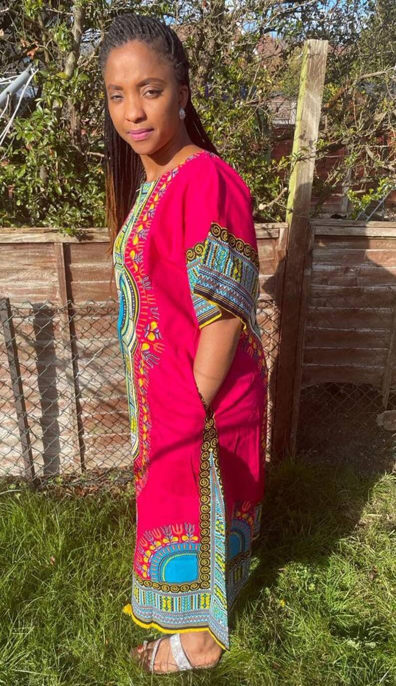 A vibrant pink African Dashiki Dress featuring traditional prints, showcasing its multi kaftan design and comfortable fit.