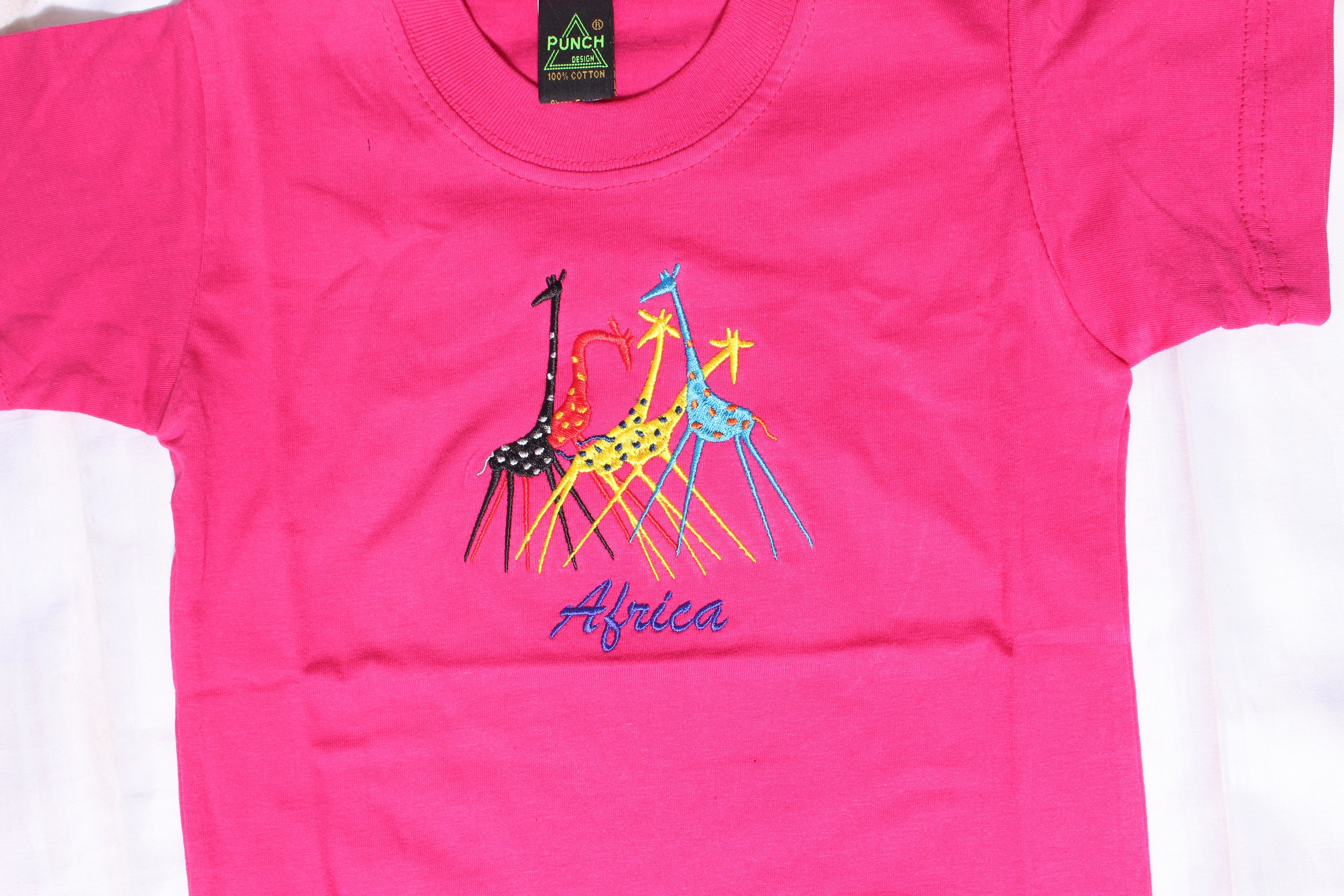 Kids' African Embroidery Round Neck T-Shirt in vibrant pink, featuring a durable ribbed neckband and double-needle hem.