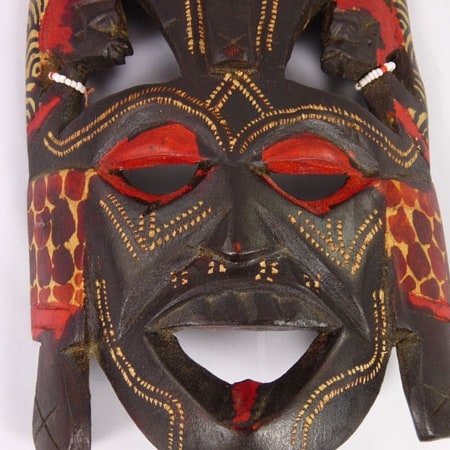 Handcrafted African wooden Kissing Mask featuring two faces and intricate animal patterns, perfect for wall decoration.