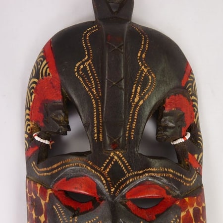 Handcrafted African wooden Kissing Mask featuring two faces and intricate animal patterns, perfect for wall decoration.