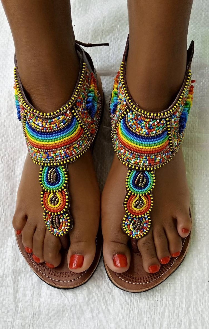 A pair of African Maasai sandals featuring colorful beadwork on soft leather, designed for summer wear with a lightweight rubber sole.