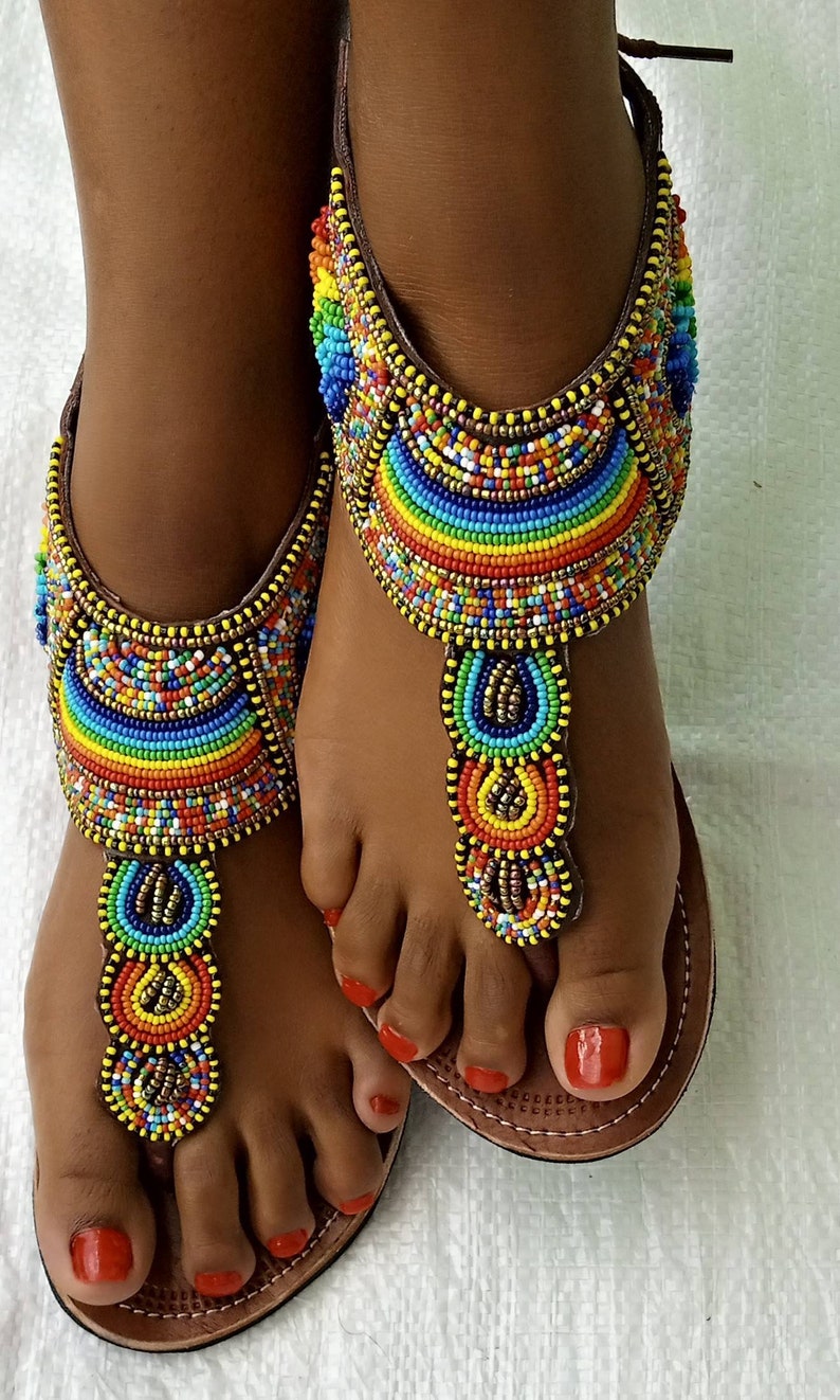 A pair of African Maasai sandals featuring colorful beadwork on soft leather, designed for summer wear with a lightweight rubber sole.