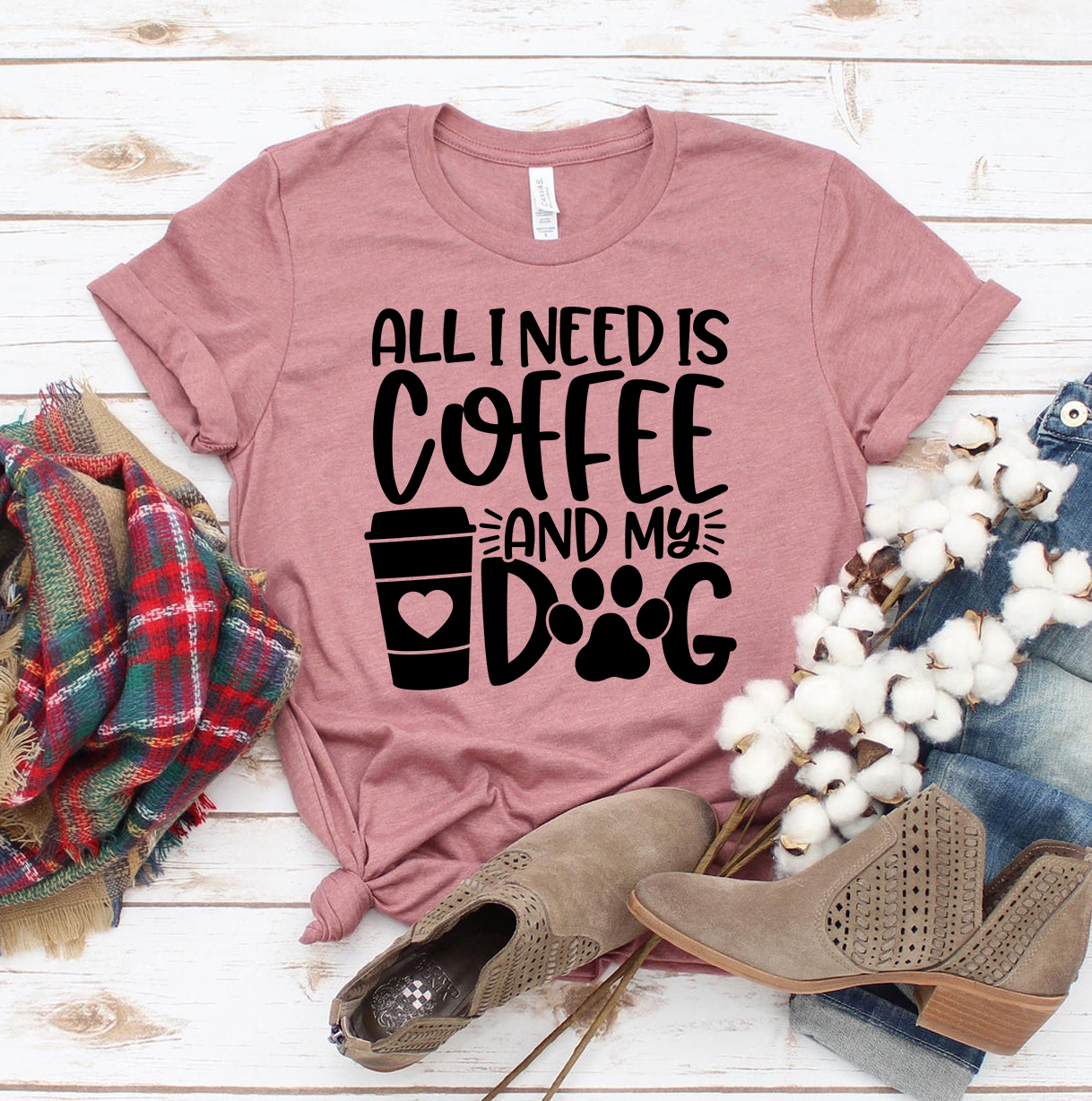 A stylish t-shirt featuring the phrase 'All I Need Is Coffee And My Dog', made from premium ring spun cotton.