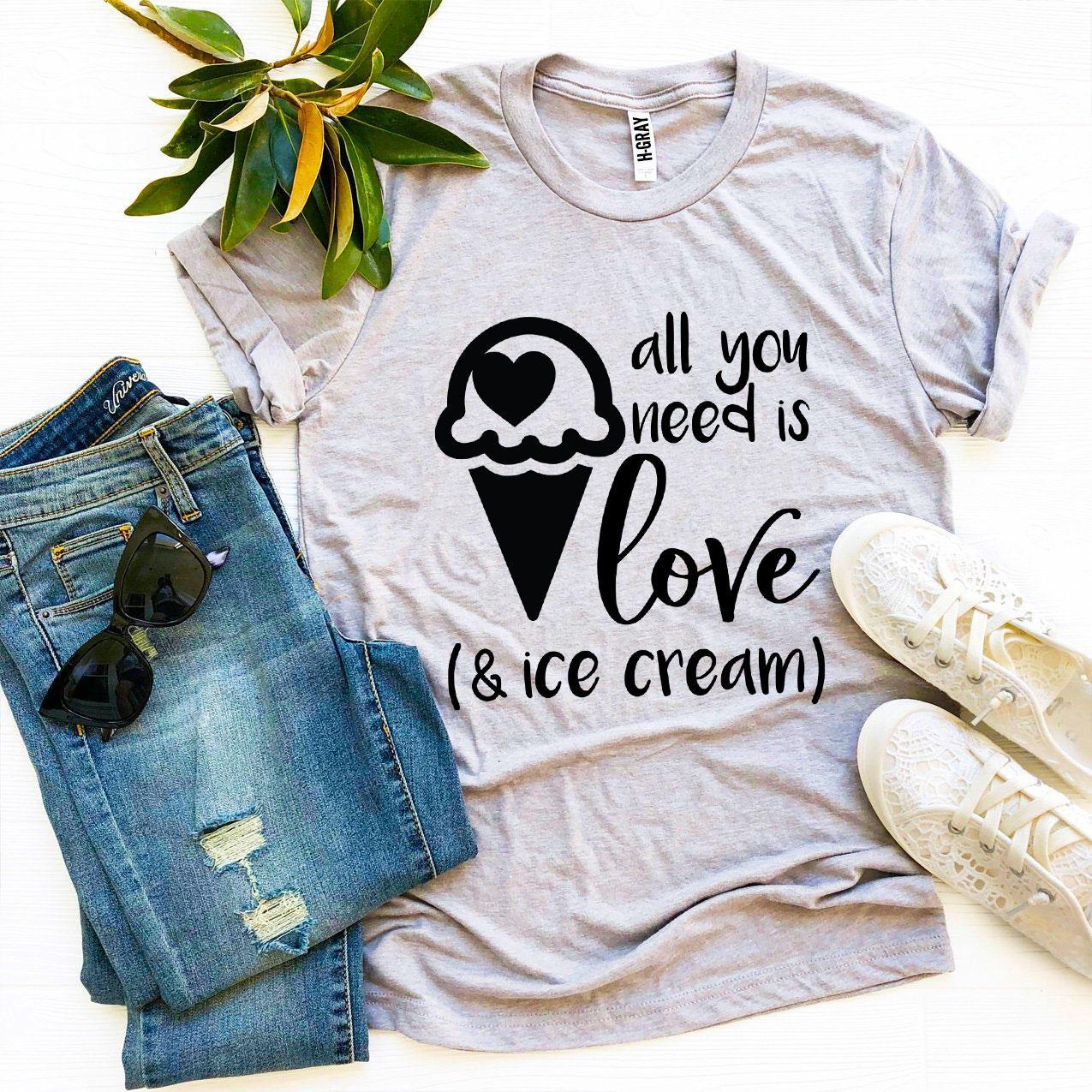 A stylish t-shirt featuring the phrase 'All You Need Is Love And Ice Cream' printed in vibrant colors on a soft fabric.