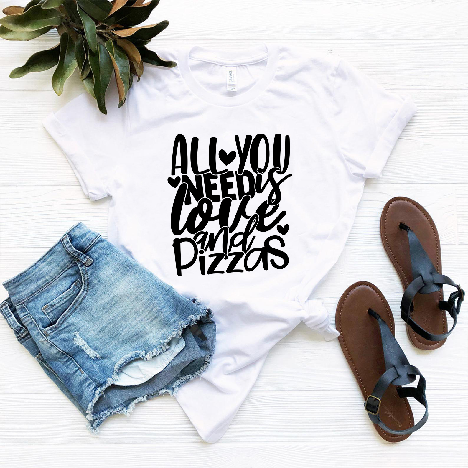 Unisex T-shirt featuring the phrase 'All You Need Is Love And Pizzas' in vibrant colors, made from soft ring spun cotton.