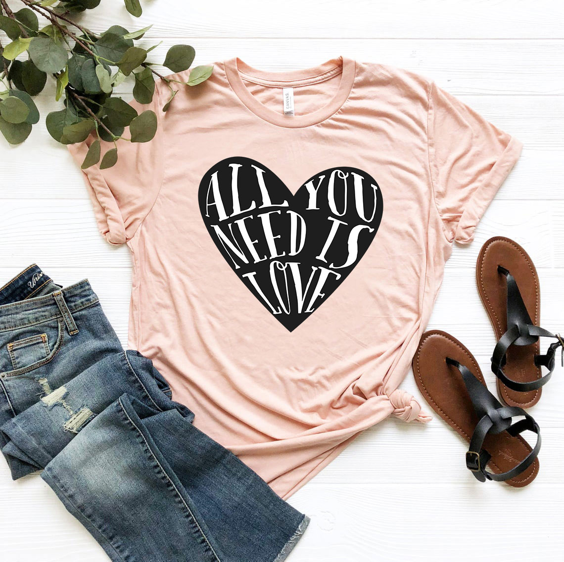 Unisex All You Need Is Love Shirt in various colors, showcasing its soft fabric and stylish design.