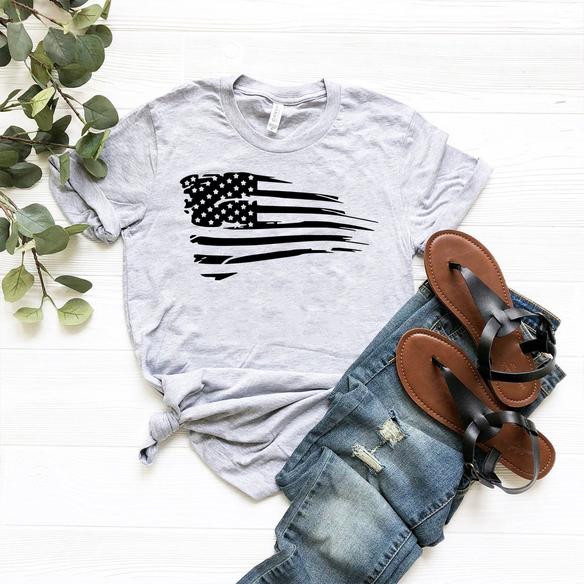 A unisex American Flag Shirt made of soft ring spun cotton, featuring a vibrant print of the American flag on the front.