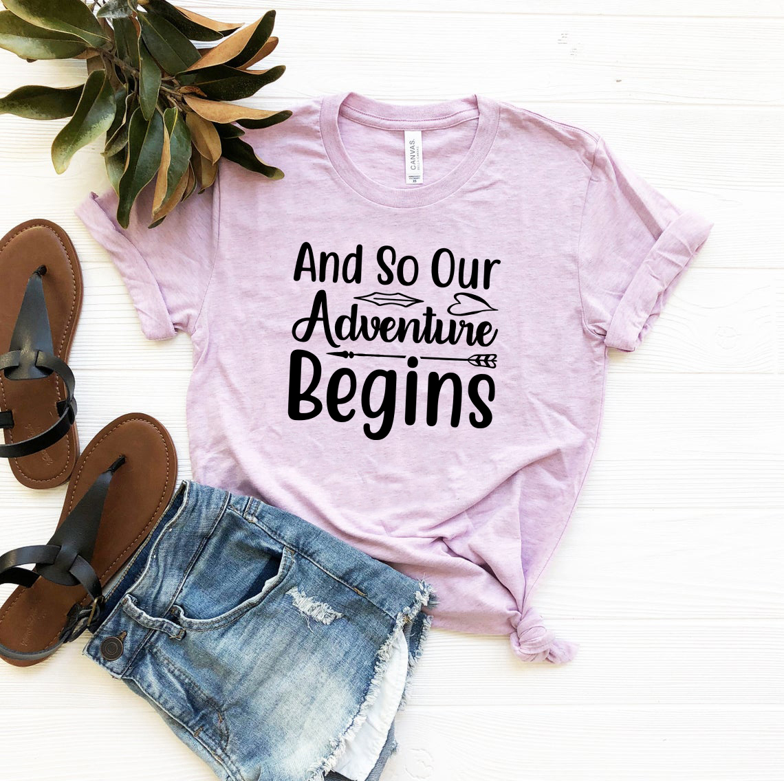 Unisex T-shirt featuring the phrase 'And So Our Adventure Begins' in a stylish design, made from soft ring spun cotton.