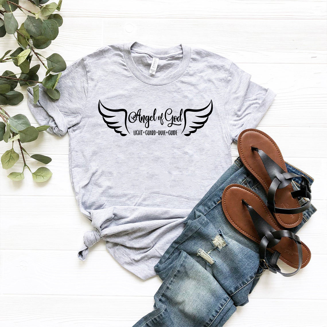 Angel Of God Unisex T-shirt in various colors, showcasing its soft fabric and stylish design.