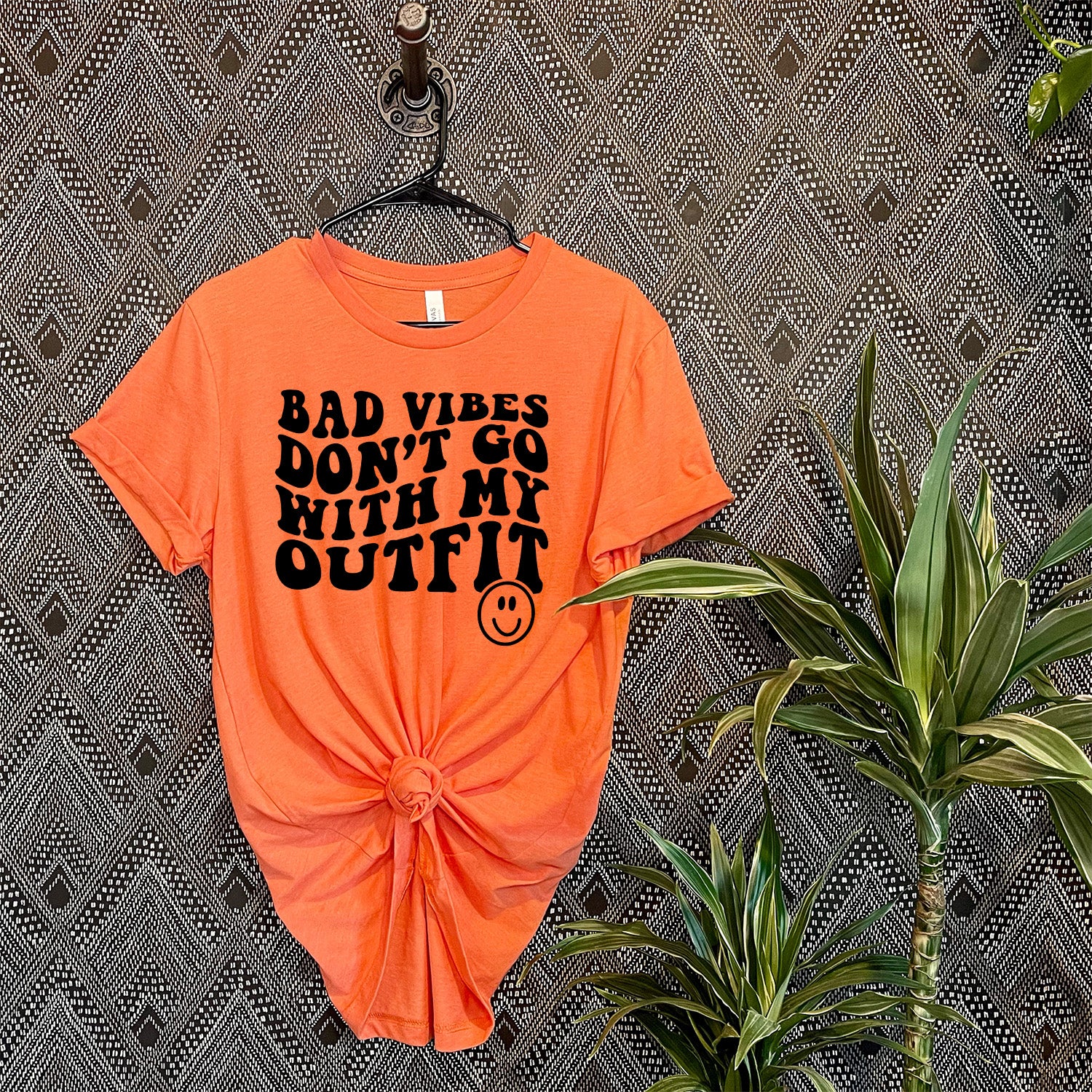 Bad Vibes Outfit Smiley Face Unisex T-shirt featuring a vibrant smiley face graphic on a soft fabric.