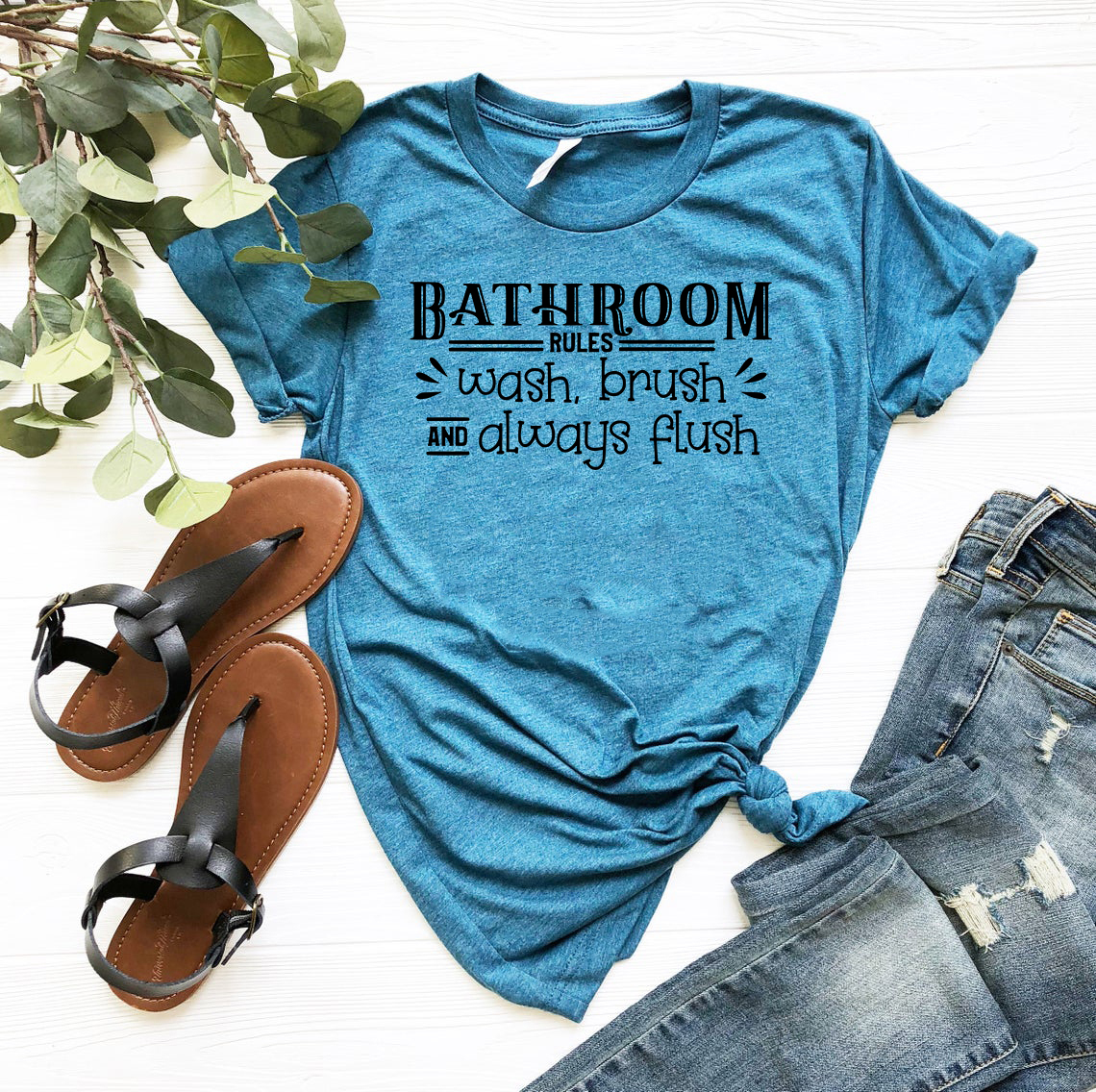 A unisex Bathroom Rules Shirt made from soft ring spun cotton, featuring a humorous print, available in various colors and sizes.