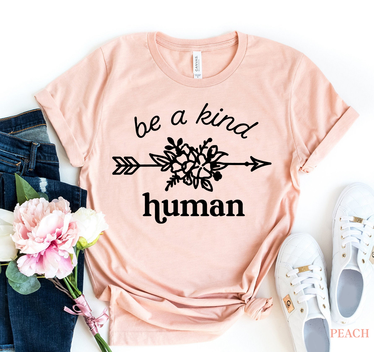 Be A Kind Human T-shirt displayed on a hanger, showcasing its soft fabric and classic design.