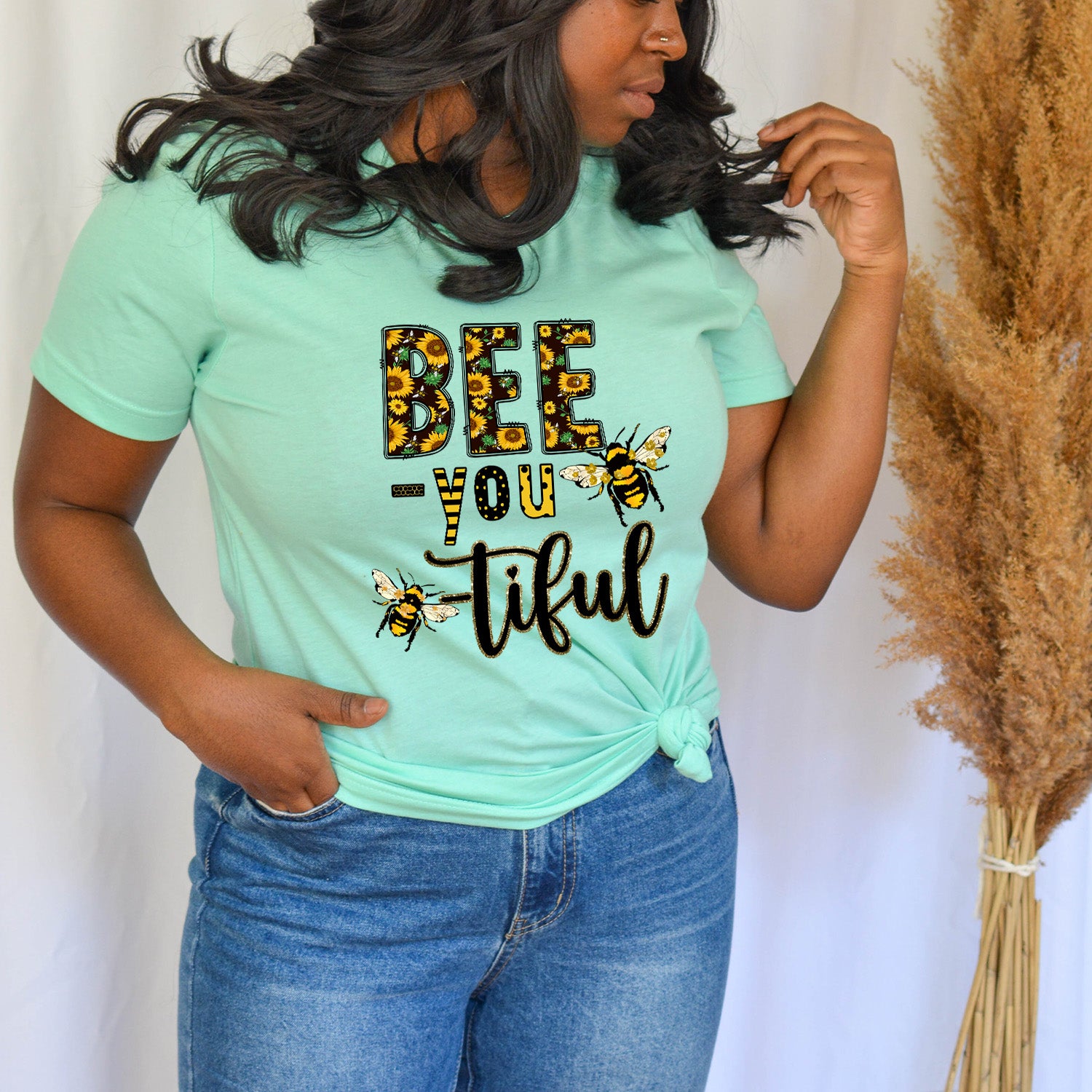 Bee You-tiful Sunflower Unisex T-shirt featuring a vibrant sunflower graphic on a soft fabric.