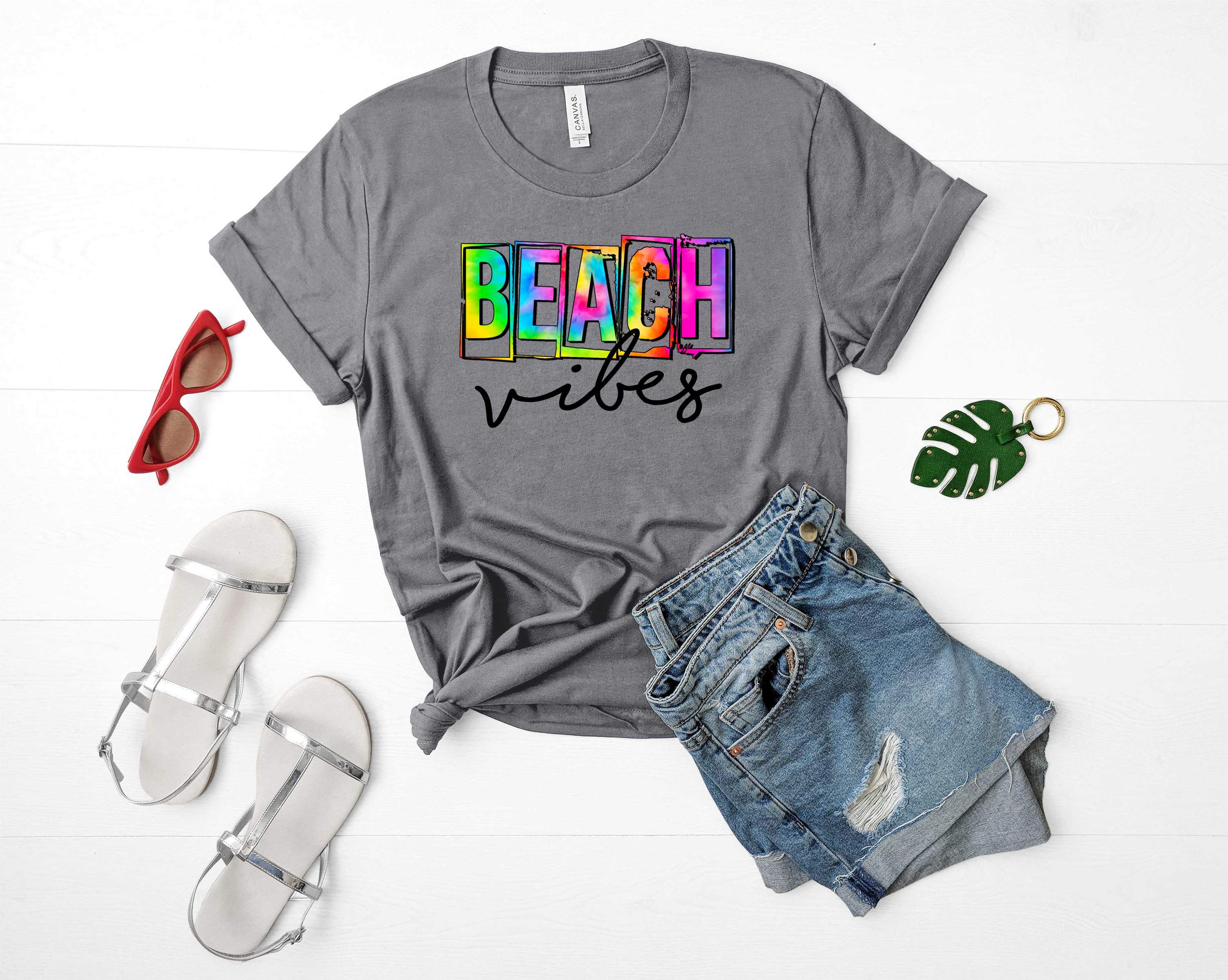 A vibrant unisex graphic tee featuring beach-themed designs, perfect for summer wear.