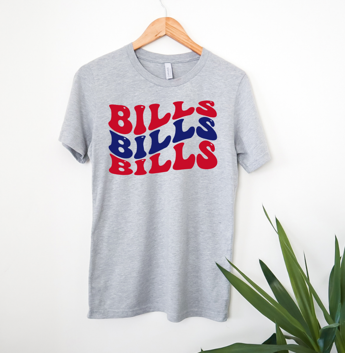 Bills Bills Bills Unisex T-shirt displayed on a neutral background, showcasing its vibrant graphic design and soft fabric.