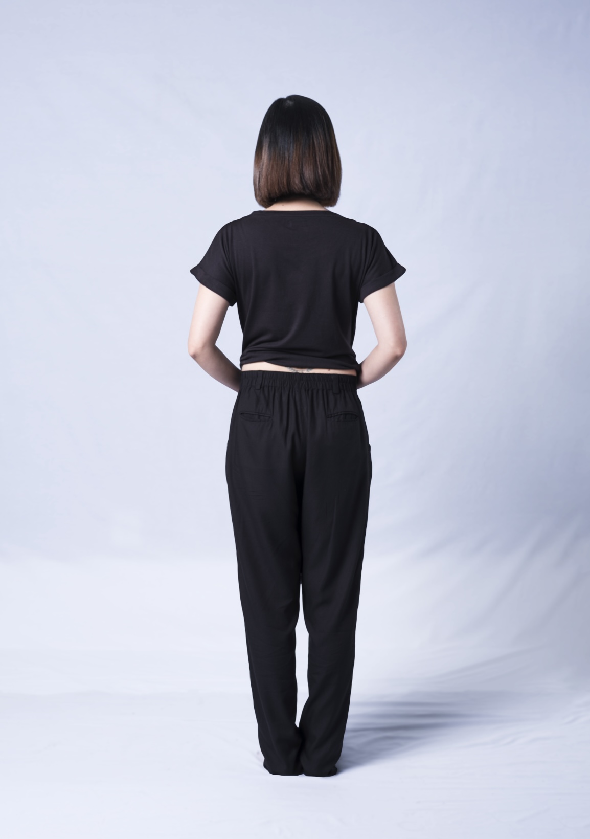 A stylish black t-shirt featuring a wide neck, oversized fit, and rolled sleeves, made from a soft cotton-modal blend.