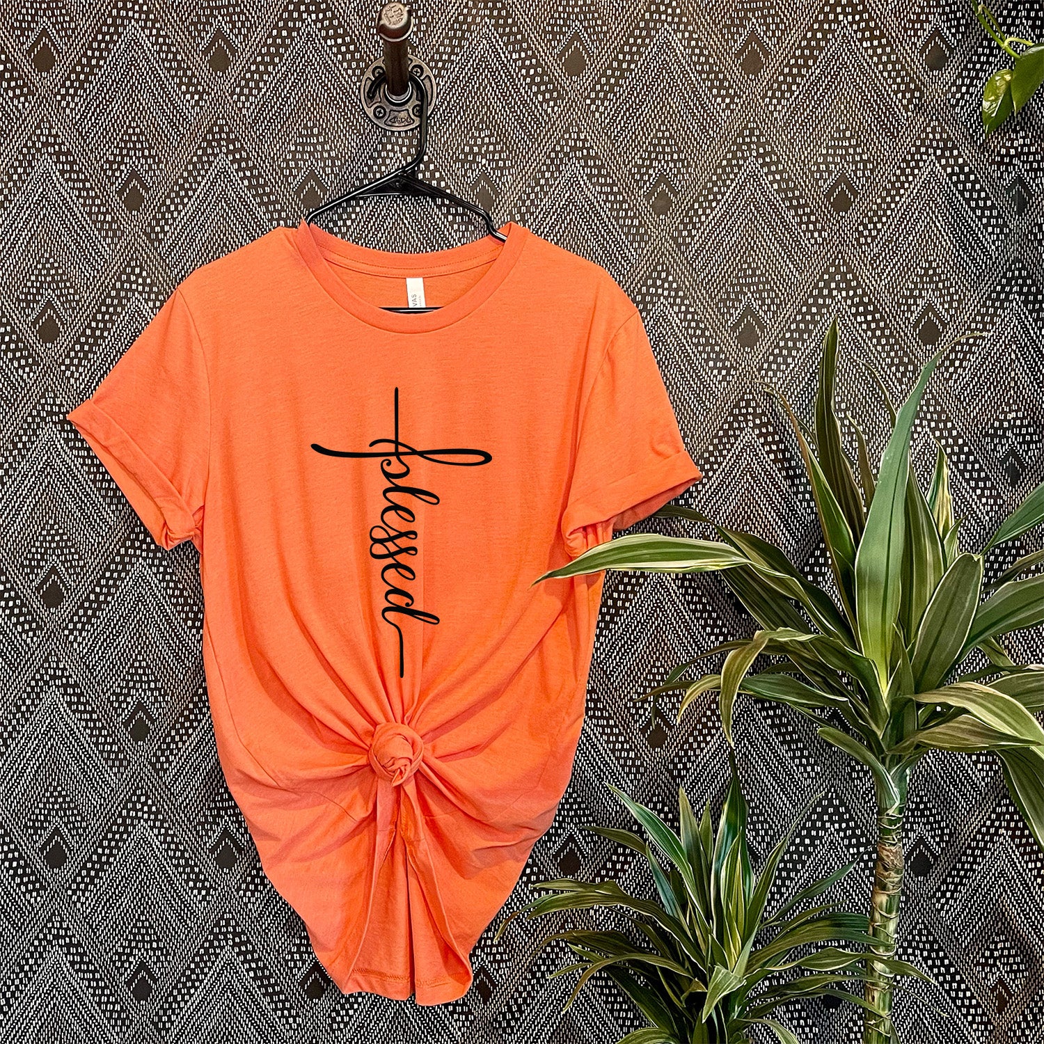 A Blessed Cross T-shirt featuring a vibrant cross graphic printed directly into the fabric, showcasing its soft texture and quality.